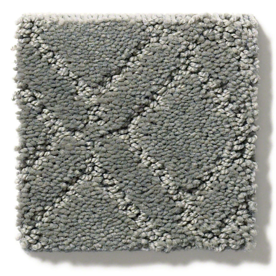 The Muse On Trend Carpet features a gray textured square swatch with a raised diamond box grid pattern. Its short, dense fibers create a soft, plush look in neutral shades, offering versatile style for any space.