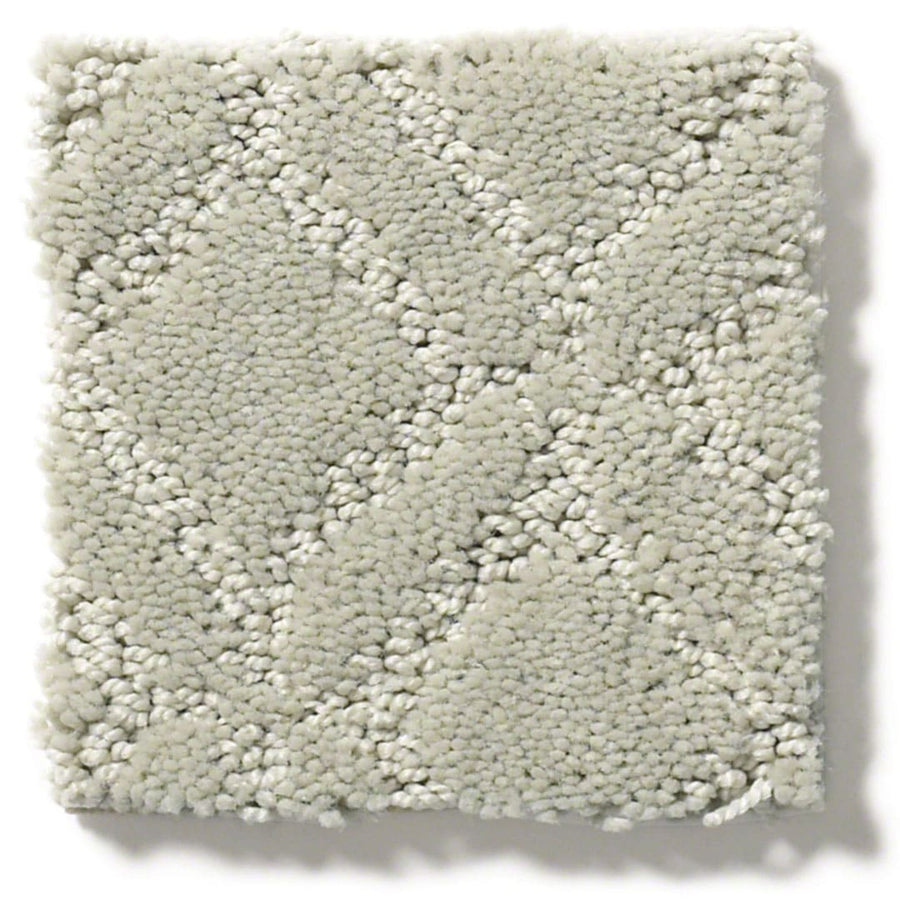 A swatch of Muse On Trend Carpet in light gray, showcasing a subtle diamond pattern in neutral shades with a plush, textured surface.
