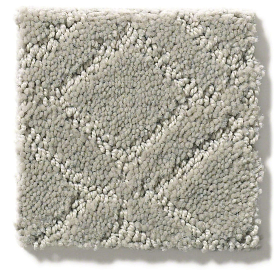 The Muse On Trend Carpet is a square swatch in light gray, featuring a plush surface with a textured diamond pattern. Raised sections create a modern geometric look, blending soft comfort and contemporary style in neutral tones.