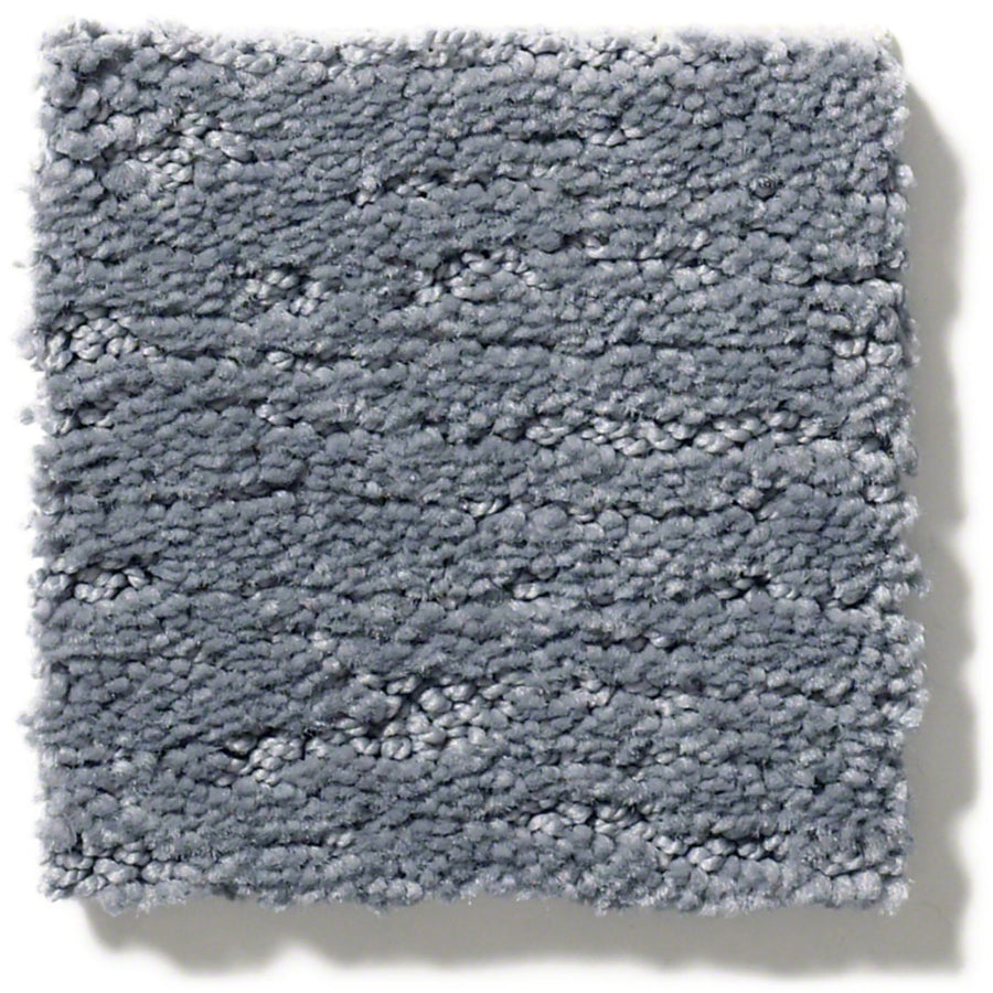 The Sketch On Trend Carpet is a light gray, soil- and stain-resistant nylon textured carpet swatch with a soft, plush surface and subtle horizontal lines in nature-inspired neutrals.