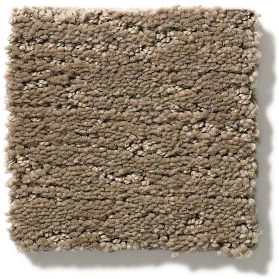 The Sketch On Trend Carpet swatch features a light brown taupe hue, thick textured pile, and slightly uneven edges. Made from soil- and stain-resistant nylon, it’s displayed against a white background.