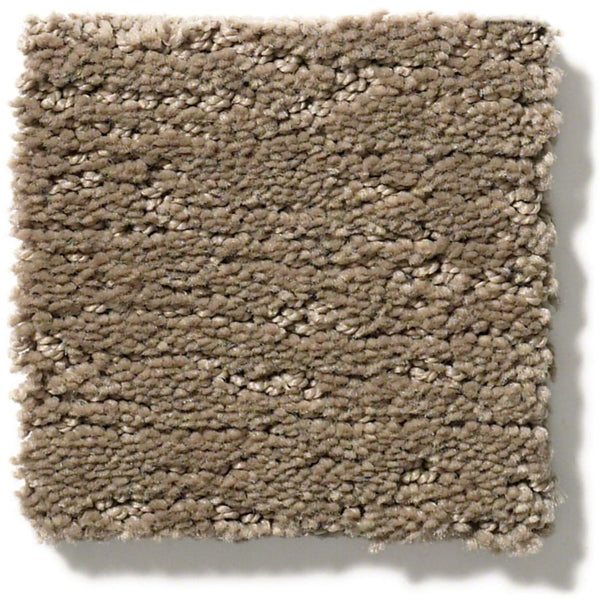 The Sketch On Trend Carpet swatch features a light brown taupe hue, thick textured pile, and slightly uneven edges. Made from soil- and stain-resistant nylon, it’s displayed against a white background.