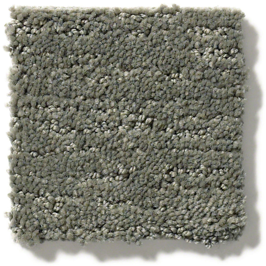 A close-up of Sketch On Trend Carpet, a light gray square sample with looped pile and subtle color variations in nature-inspired neutrals. The carpet's edges appear slightly uneven.