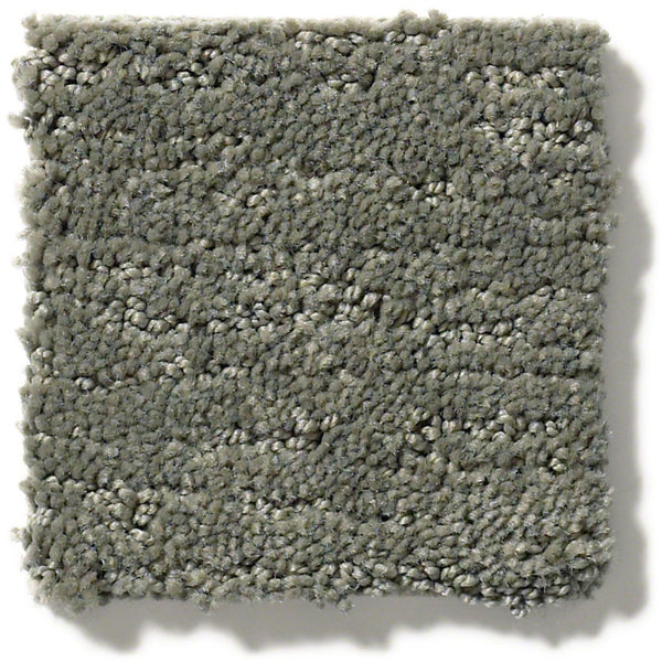 A close-up of Sketch On Trend Carpet, a light gray square sample with looped pile and subtle color variations in nature-inspired neutrals. The carpet's edges appear slightly uneven.
