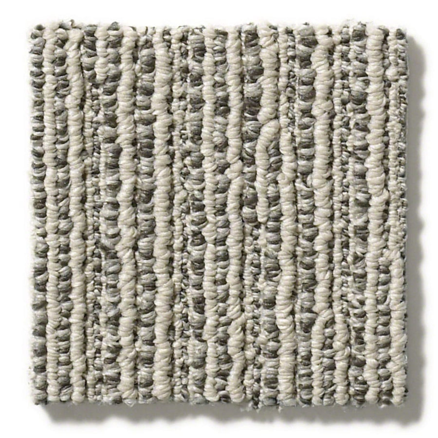 The Chase Pet Friendly Carpet swatch features a patterned loop with soft linear texture and alternating rows of light beige and gray fibers, creating a striped, textured look that adds interest to any space.