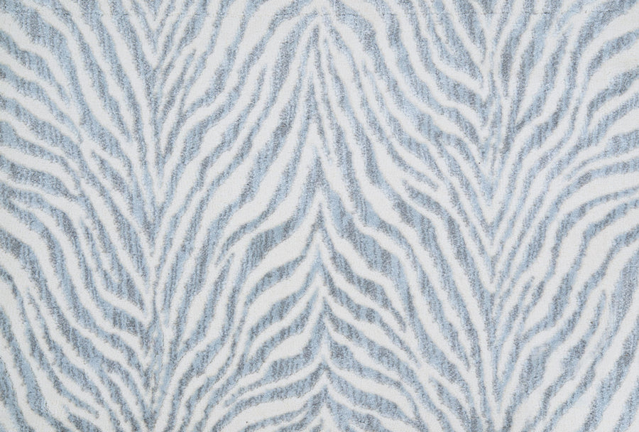The Boteti On Trend Carpet features soft, wavy light gray and white zebra stripes in a symmetrical pattern. This animal-inspired carpet adds a modern touch to contemporary décor, repeating elegantly across the surface with a textured look.