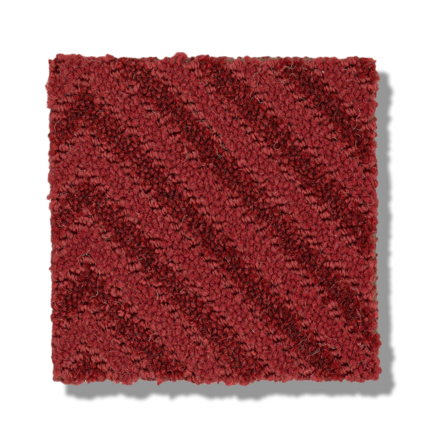 A square swatch of Aristocrat On Trend Carpet in deep red, featuring a subtle diagonal stripe and matte texture, is shown on a white background for striking contrast.