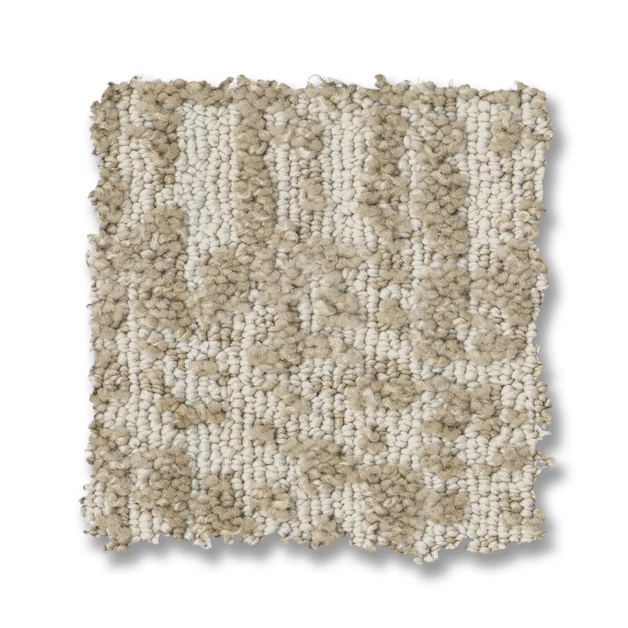 A square swatch of Batique On Trend Carpet displays an abstract, textured looped pile in beige and cream tones, with an irregular surface and uneven edges set against a white background.