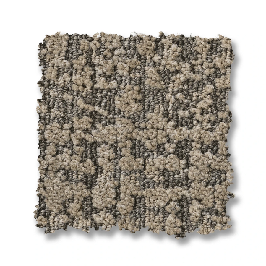 The Batique On Trend Carpet swatch is square with a looped, textured pattern and an irregular geometric design in beige and gray tones, creating an abstract look. It is displayed on a white background.