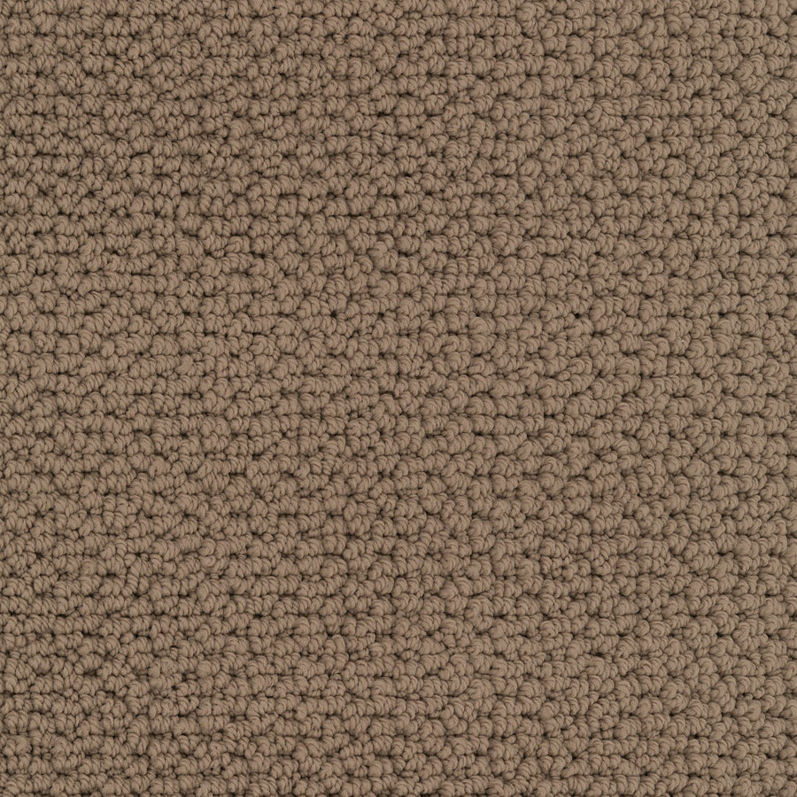 Close-up of Beachfront Berber Carpet, a textured brown performance carpet with tightly looped EnVision nylon fibers. Its uniform, slightly rough surface features neutral natural colors and subtle shading from the fiber arrangement.