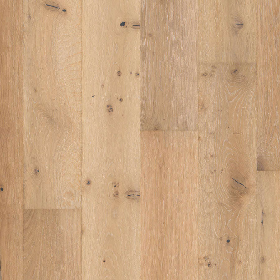 Biltmore Hickory & White Oak 7 1/2" Hardwood features light-colored white oak planks with visible grain and knots, a natural low-gloss finish, and unique texture and tone variations for an authentic hardwood look.