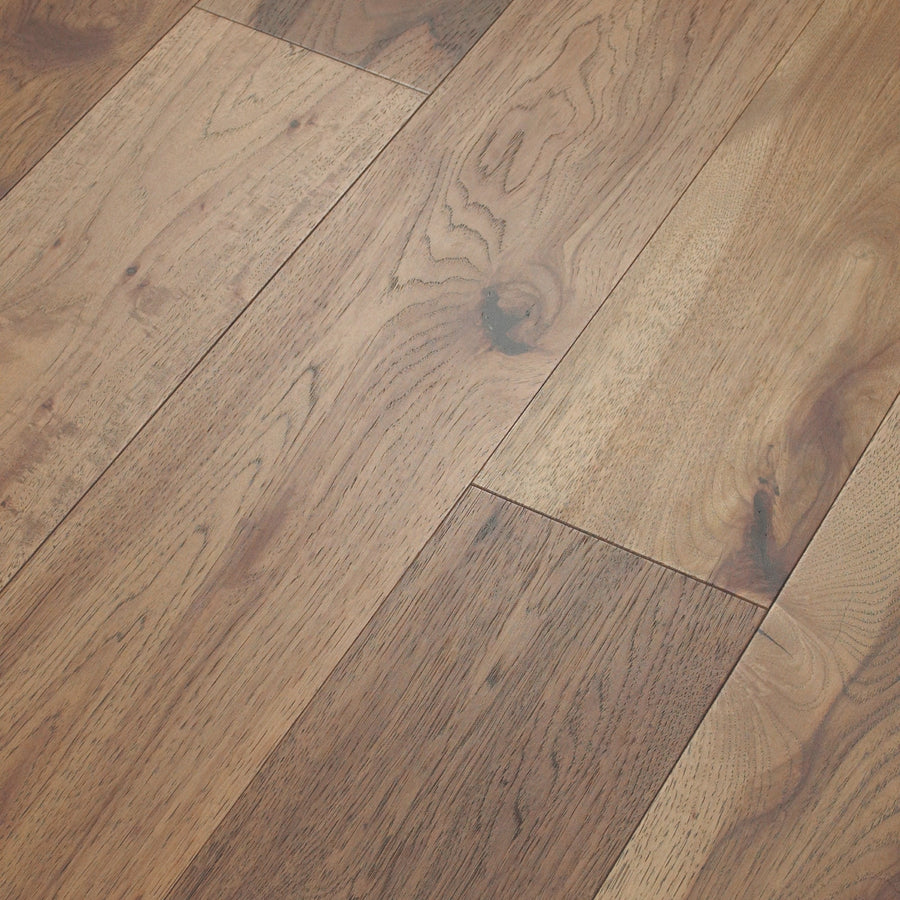Close-up of Birmingham Pecan 7 1/2" Hardwood flooring featuring natural brown hues, visible wood grain patterns, and lengthwise-aligned boards that accentuate color and texture variations.