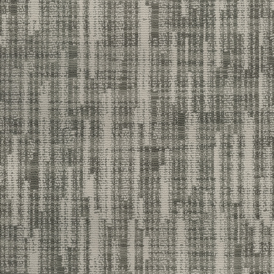 A close-up of the Blurred Lines On Trend Carpet shows its woven, textured fabric in varying gray shades, creating a modern, abstract grid pattern inspired by photography.