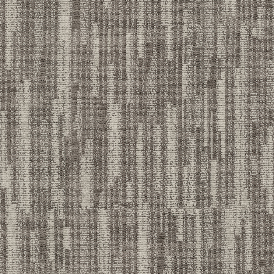 A close-up of Blurred Lines On Trend Carpet shows a textured woven pattern with vertical and horizontal stripes in beige, taupe, and brown, creating an abstract, modern design inspired by photography.