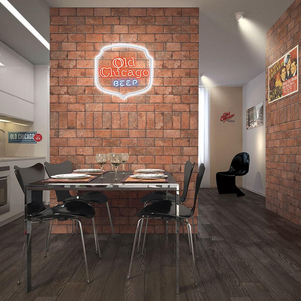 A modern dining area features a glass table, four black chairs, and an accent wall clad in Chicago 4x8 Brick Tile with a neon “Old Chicago Beer” sign. Wine glasses and plates set on the table; posters decorate the nearby walls.