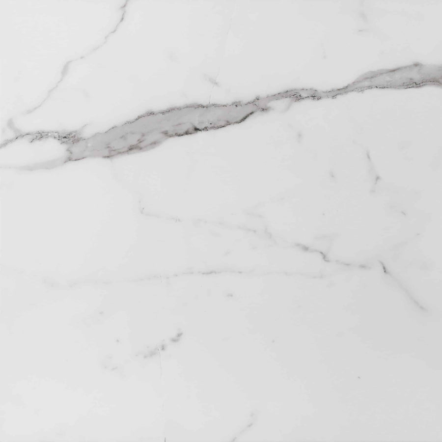 Buckingham Palace 24x24 Porcelain Tile features a white marble-look surface with delicate grey veining running diagonally, creating a sophisticated and elegant pattern. Its smooth, polished texture adds luxury to any space.