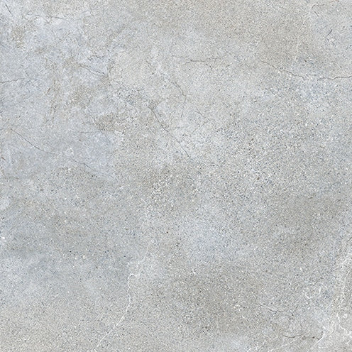 A close-up of the Santorini 24x24 Porcelain Tile shows its light gray stone-effect surface, featuring tactile elegance with subtle color variations and faint, natural-looking cracks.