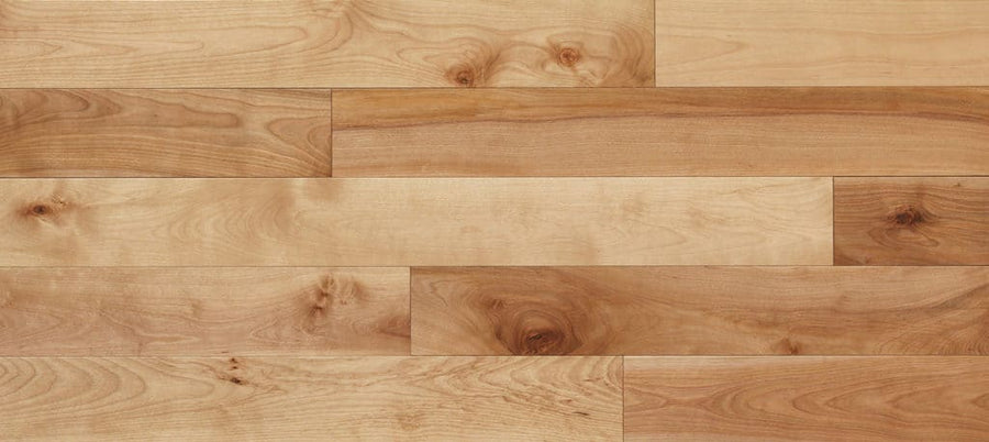 Charm City 5" Yellow Birch Hardwood features light-toned, solid planks with natural grain and knots in a staggered layout. This durable flooring has a smooth finish in shades of tan and light brown.