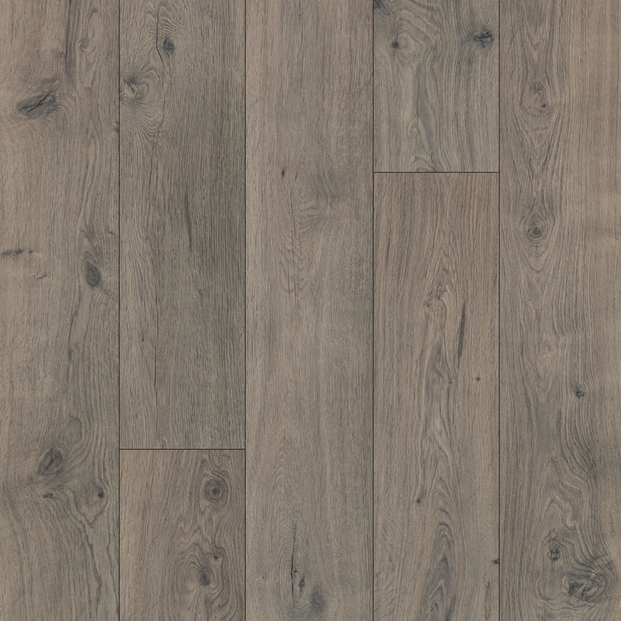 Close-up of Hill Valley 7.5" Waterproof Laminate floors with a natural, weathered look; visible wood grain and knots in brown and gray create a rustic, textured appearance.