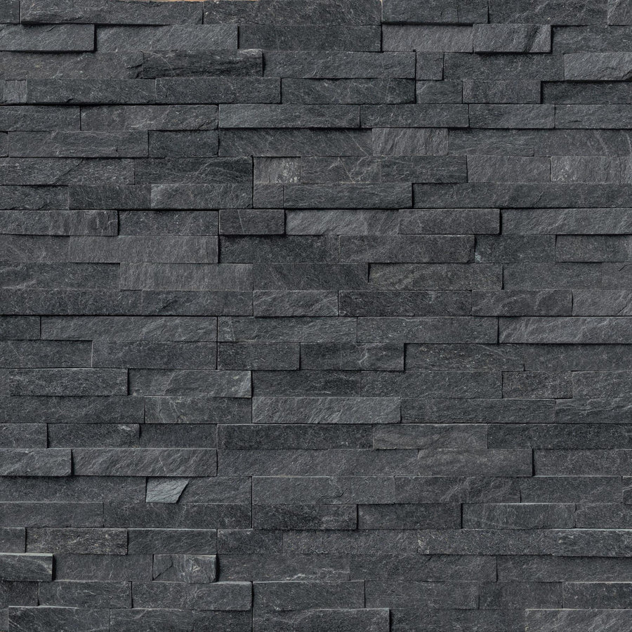 The Landscape 6x24 Natural Stone Ledger Panel features dark gray stacked stone with uneven rectangular pieces in various sizes and textures, delivering a modern, layered look—ideal for stylish wall designs using split face stone.