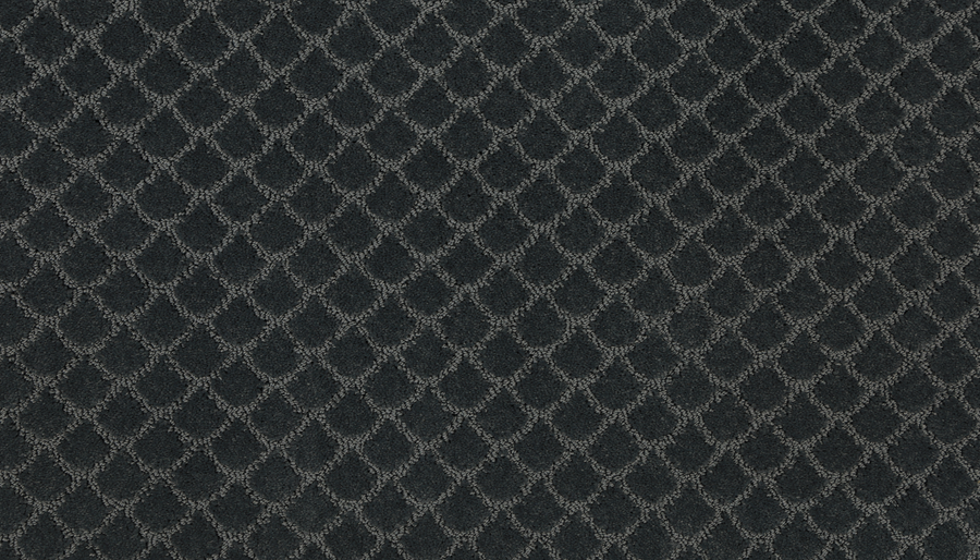 A close-up of Design Paradise Family Friendly Carpet reveals dark gray textured fabric with a diamond-shaped lattice pattern in earthy tones, creating a warm, inviting look.