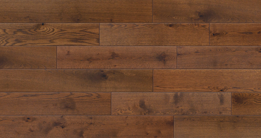 Close-up of Valor Hall 7 1/2" White Oak Hardwood shows wide, warm-toned planks with rich grain and natural knots, giving this engineered flooring a textured, rustic, and inviting look.