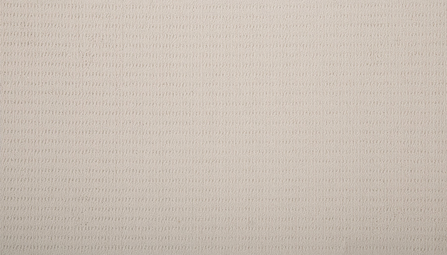 A close-up of Eloquent Vision Family Friendly Carpet in light beige shows its soft, uniform surface with a subtle horizontal ribbed pattern, featuring evenly spaced lines across this luxurious and durable flooring.