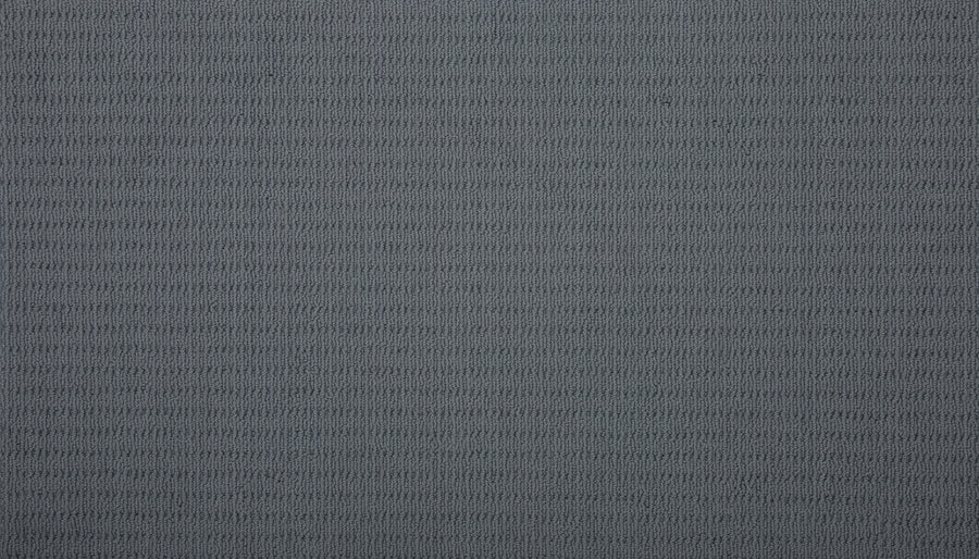 Close-up of the Eloquent Vision Family Friendly Carpet in gray, featuring a subtle repeating horizontal pattern. Its soft texture and gentle ridges add depth, making it a sophisticated choice for luxury flooring.