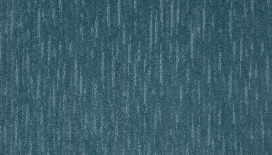 A close-up of Exciting Choice Family Friendly Carpet shows a textured blue surface with subtle vertical streaks in varying shades, offering a stylish and family-friendly modern pattern.