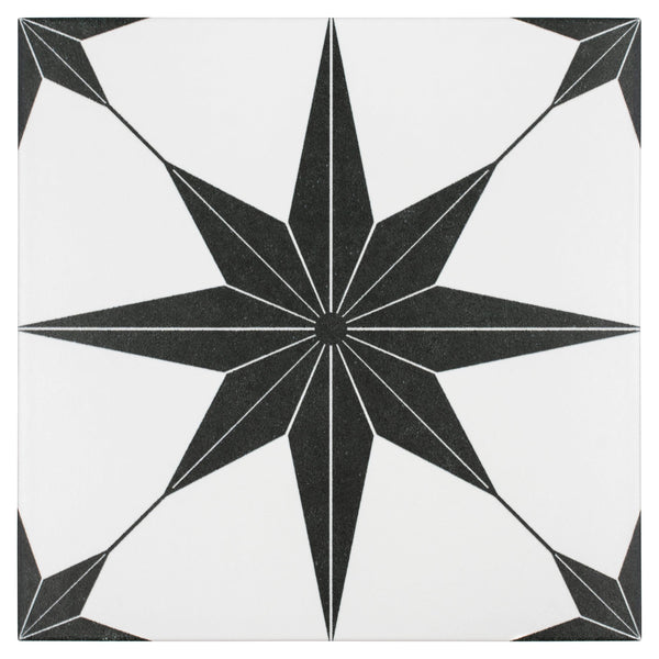 The Stella 9 3/4 x 9 3/4 Patterned Tile is a white tile showcasing a bold black eight-pointed starburst with thin radiating lines reaching toward each corner.