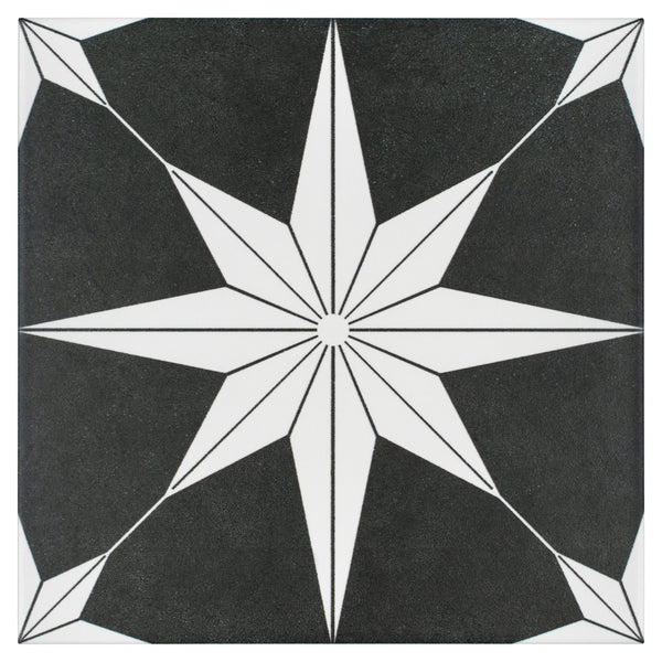 The Stella 9 3/4 x 9 3/4 Patterned Tile features a black and white eight-pointed starburst at the center, with geometric corners and radiating lines for a striking, modern design.