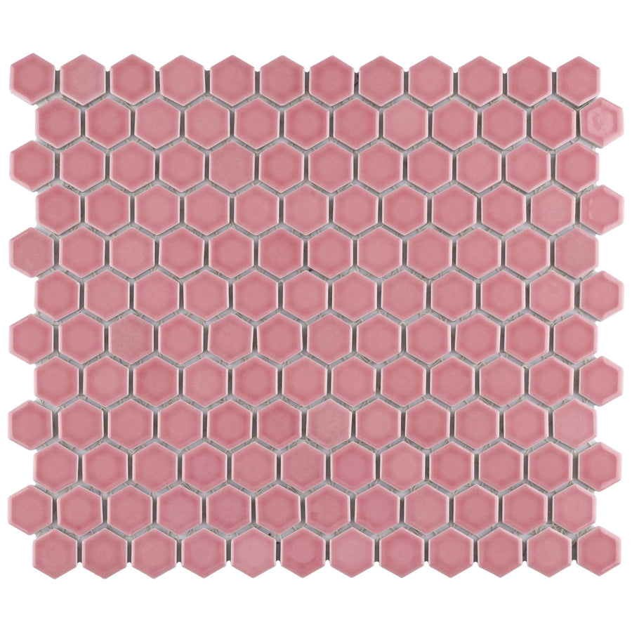 The Tribeca 1" Hex Glossy Mosaic Tile showcases pink hexagon tiles in a honeycomb pattern with white grout lines, ideal for adding stylish flair to floors and walls.