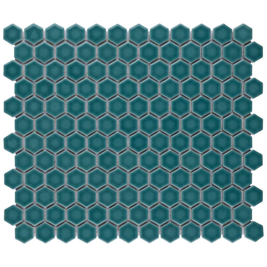 The Tribeca 1" Hex Glossy Mosaic Tile features small, teal-colored porcelain hexagons in a honeycomb pattern with gray grout lines between each tile.