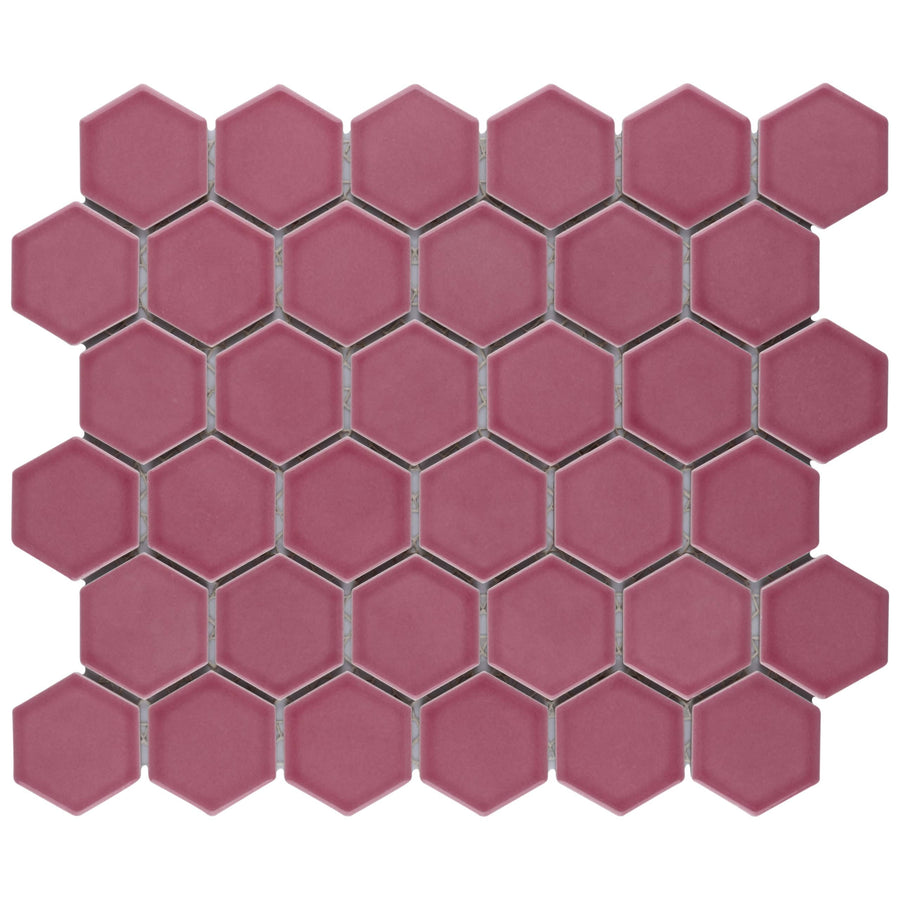 Tribeca 2" Hex Glossy Mosaic Tiles in pink feature a geometric hexagonal design with slightly beveled edges. Arranged on a white background, thin gray grout lines add a modern and striking touch to this ceramic mosaic.