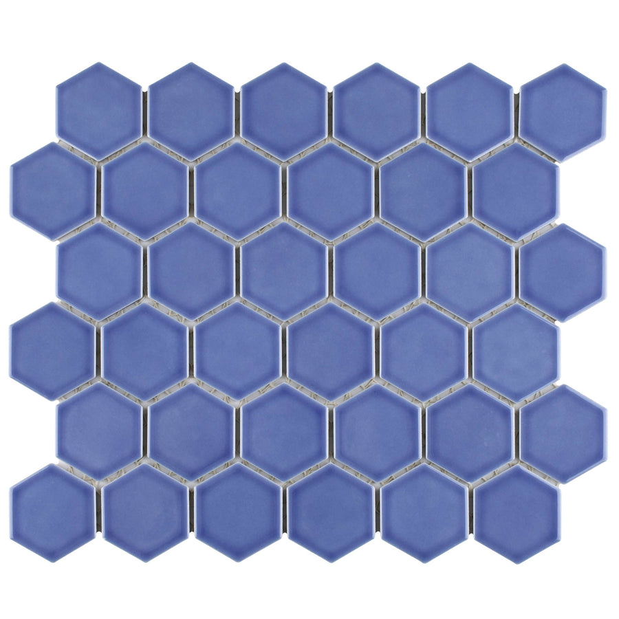 Tribeca 2" Hex Glossy Mosaic Tile features hexagonal blue porcelain pieces in a honeycomb pattern with thin white grout lines, offering a striking geometric design and a high-gloss finish.