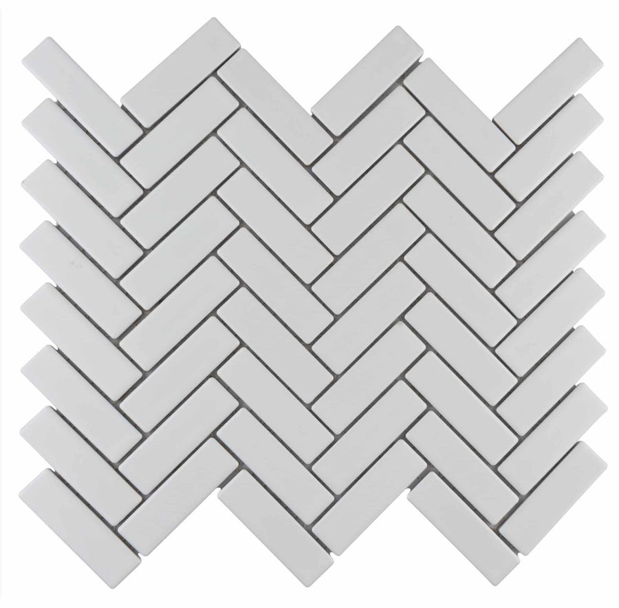 Metro Brick Herringbone Mosaic Tile features rectangular white tiles in a herringbone pattern on a white background, creating a zigzag, interlocking design.