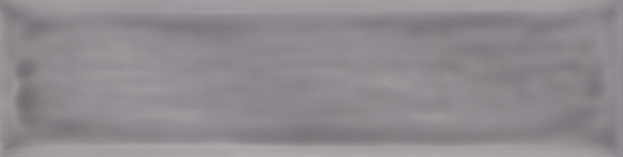 A rectangular, softly blurred gray shape evokes the misty look of the Watercolor 3x12 Subway Tile, with subtle gradients and darker edges against a light background—reminiscent of modern styles using a fresh color palette.