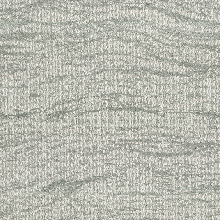 FREEstyle On Trend Carpet features light gray and white fabric in an abstract, wavy pattern for a spa-like feel. TECHnique tufting gives the soft texture a subtle, raised depth, adding dimension to this stylish carpet collection.