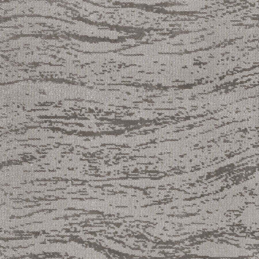 A close-up of FREEstyle On Trend Carpet shows its wavy, irregular gray pattern—crafted with TECHnique tufting—that evokes the spa-like calm of natural wood grain or rippling water.