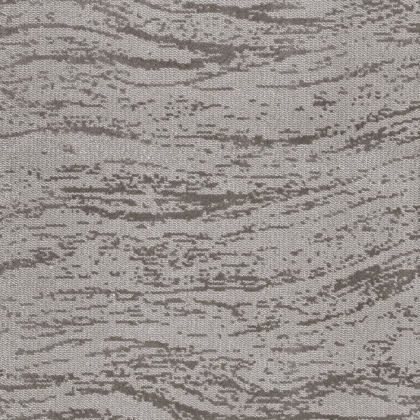 A close-up of FREEstyle On Trend Carpet shows its wavy, irregular gray pattern—crafted with TECHnique tufting—that evokes the spa-like calm of natural wood grain or rippling water.