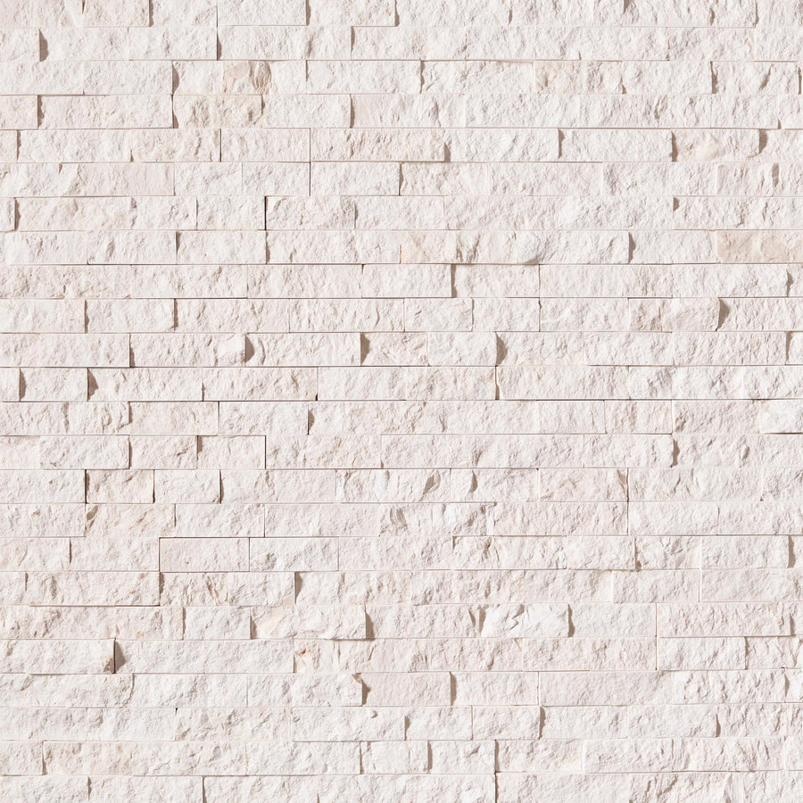 Close-up of a Landscape 6x24 Natural Stone Ledger Panel in light beige, featuring uneven rectangular bricks arranged horizontally with a textured surface and subtle color variations—ideal for modern wall design.