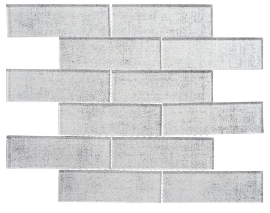 The Westminster Glass Mosaic features rectangular, light gray tiles with a slightly textured surface in a staggered pattern, offering subtle shading and a modern look—perfect for contemporary spaces.