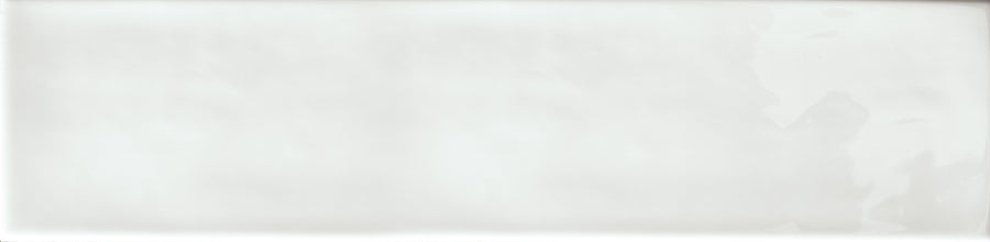 The Essence 2.5x10.5 Subway Tile is a plain, smooth, white ceramic tile featuring a glossy finish with subtle shadows and reflections on its surface.