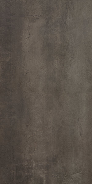 A close-up of the Platform 24x48 Porcelain Tile reveals a textured, dark brown surface with a rich palette, subtle cracks, uneven tones, and hints of a metallic look, resembling aged concrete or weathered stone.