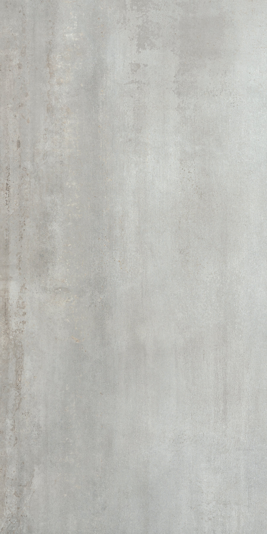 A close-up of Platform 24x48 Porcelain Tile reveals a smooth, light gray finish with subtle texture and faint vertical streaks, offering a metallic look that enhances its minimalist and industrial appeal.