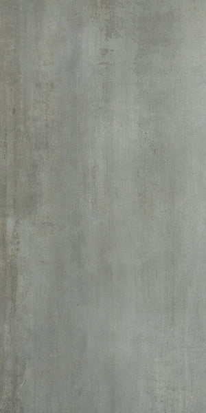 The Platform 24x48 Porcelain Tile features a textured gray concrete look with subtle tonal variations and faint streaks, creating a slightly weathered, industrial style reminiscent of metal cladding.