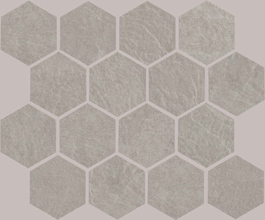 Slide 3" Hex Porcelain Tile features light gray hexagons with a subtle stone texture, arranged in a honeycomb pattern on a pale pink background for a refined contemporary look.