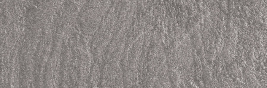 Close-up of the Slide 4x12 Porcelain Tile's textured gray stone surface, featuring irregular patterns and subtle shading—perfect for adding a modern, slate-inspired look to contemporary spaces.