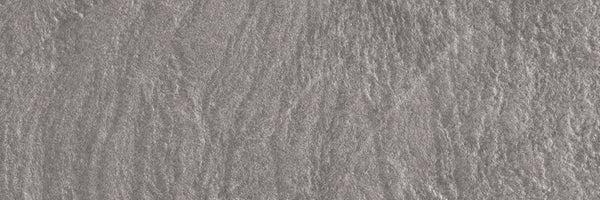 Close-up of the Slide 4x12 Porcelain Tile's textured gray stone surface, featuring irregular patterns and subtle shading—perfect for adding a modern, slate-inspired look to contemporary spaces.
