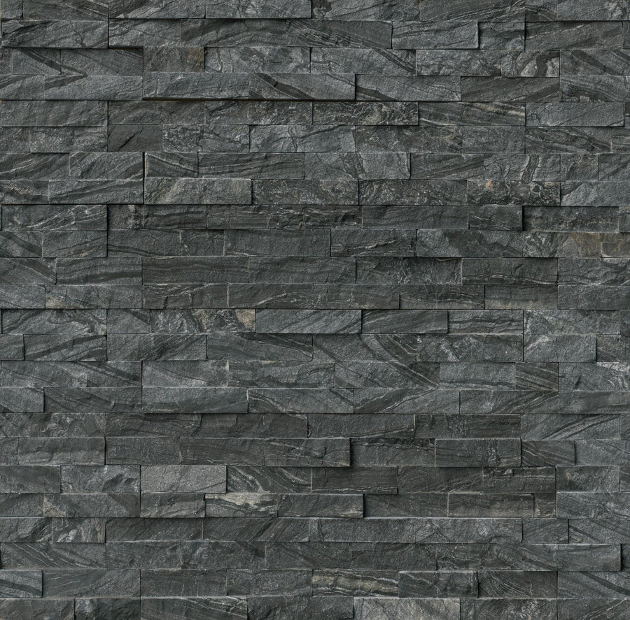 Close-up of a Landscape 6x24 Natural Stone Ledger Panel in dark gray, featuring rectangular, unevenly stacked stones of varying sizes and textures for a layered surface ideal for modern wall design.